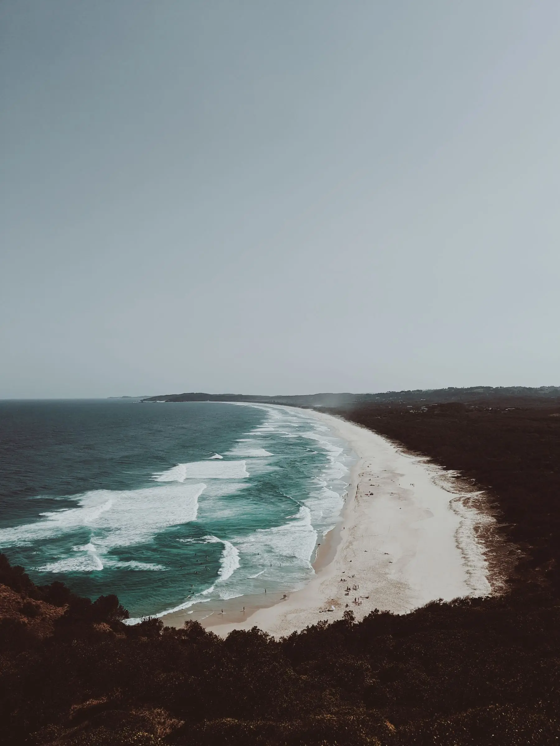 Aerial view of the coastline near Lennox Head, with surf rolling onto the beach