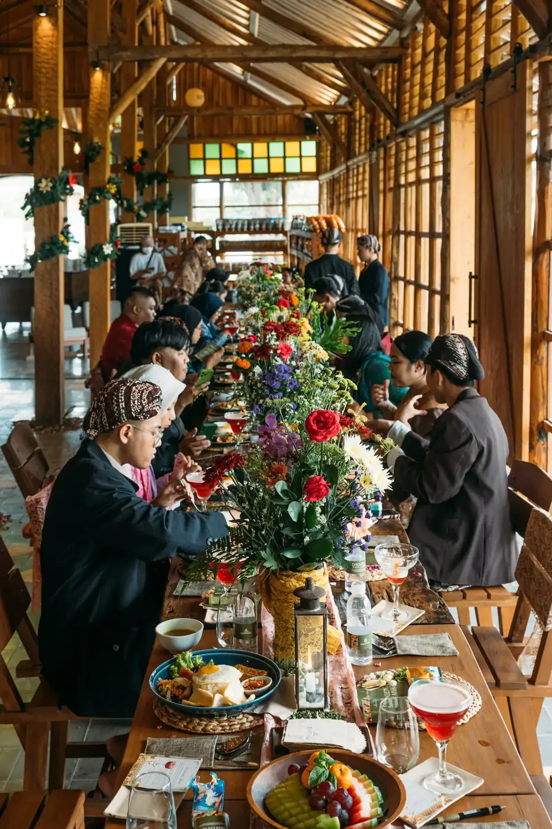 A community group sharing a meal around a long table